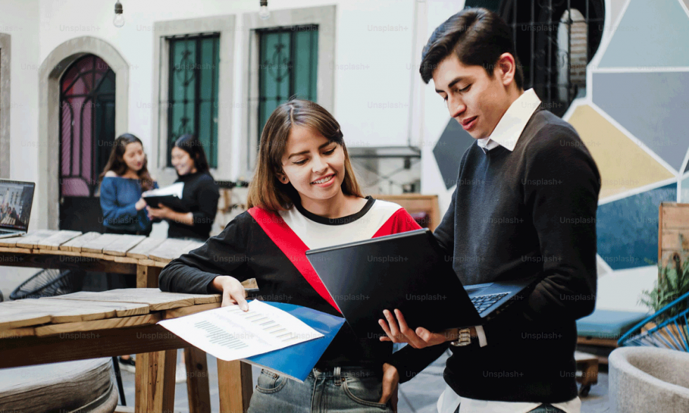 Jovenes universitarios latinoamericanos leyendo un libro sonriendo